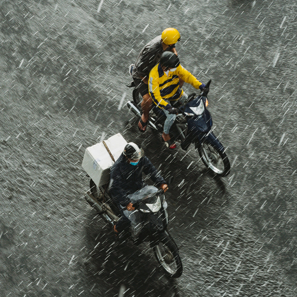 What should you pay attention to when riding a motorcycle on rainy days?